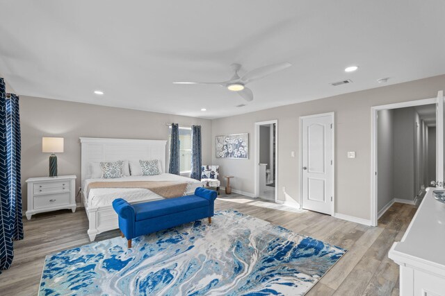 bedroom featuring light wood-style flooring, visible vents, ceiling fan, and baseboards