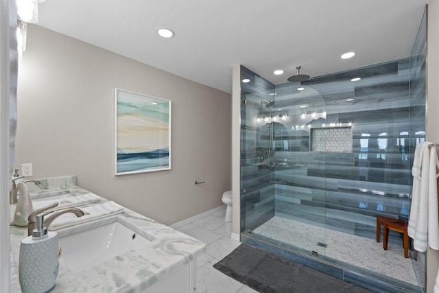 full bath featuring a stall shower, baseboards, toilet, marble finish floor, and a sink