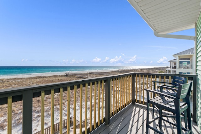 balcony with a water view and a beach view