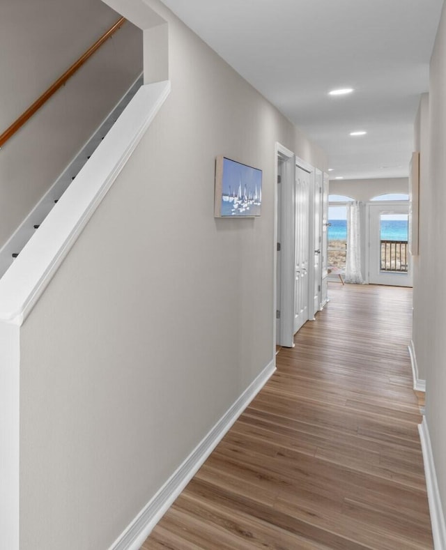 hall with wood finished floors and baseboards