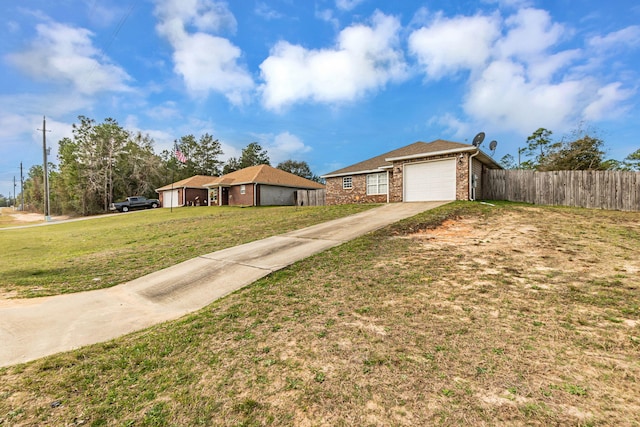 single story home featuring driveway, fence, a front lawn, and brick siding