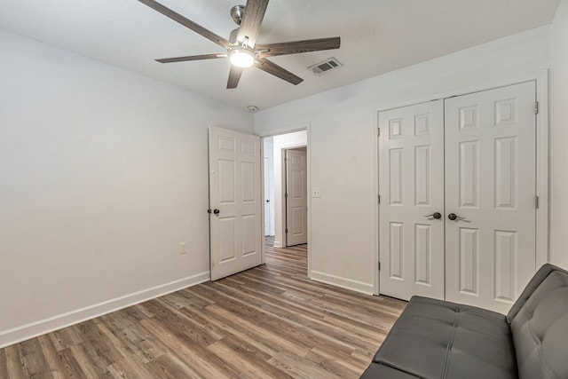 interior space with light wood-type flooring, visible vents, and baseboards