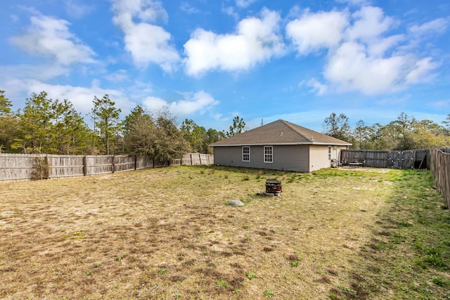 view of yard featuring an outdoor fire pit and a fenced backyard