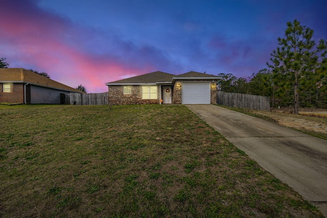 view of front of home with a garage, a front yard, concrete driveway, and fence