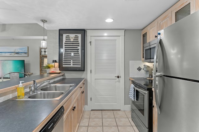 kitchen with light tile patterned flooring, light brown cabinets, stainless steel appliances, a sink, and dark countertops