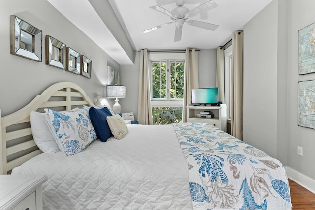 bedroom with ceiling fan, baseboards, and wood finished floors