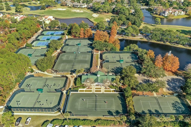 birds eye view of property with a water view and view of golf course