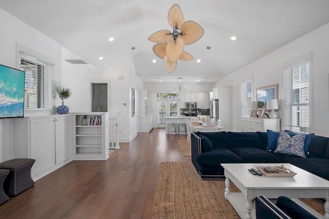 living room with vaulted ceiling, dark wood-style floors, visible vents, and recessed lighting