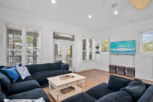 living room featuring recessed lighting, french doors, visible vents, and wood finished floors