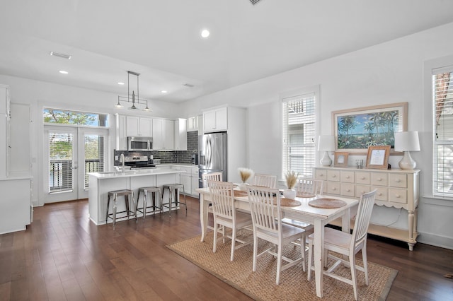 dining space with baseboards, dark wood finished floors, and recessed lighting