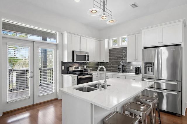 kitchen featuring plenty of natural light, visible vents, appliances with stainless steel finishes, and a sink