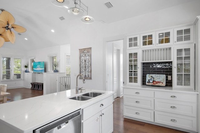 kitchen with visible vents, stainless steel dishwasher, dark wood-type flooring, white cabinets, and a sink