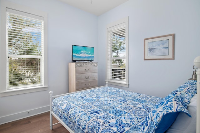 bedroom featuring baseboards and wood finished floors