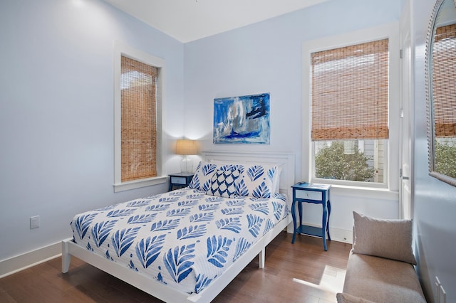 bedroom featuring baseboards and wood finished floors