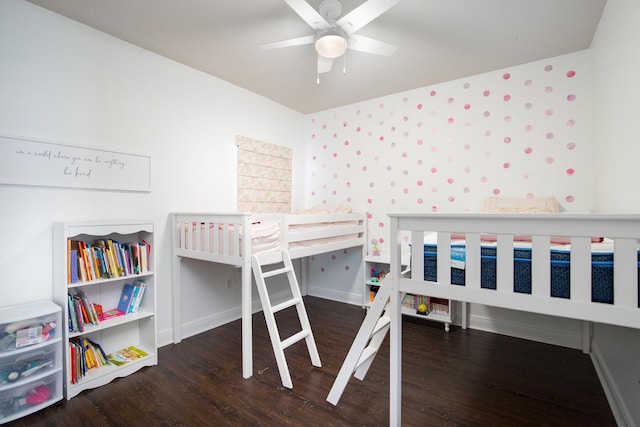 bedroom with a ceiling fan, baseboards, and wood finished floors