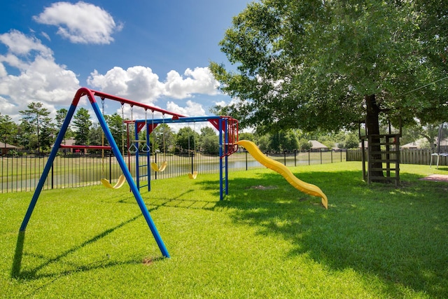 community play area with a yard and fence