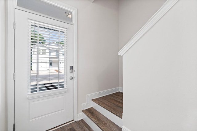 doorway featuring dark wood-style floors and baseboards