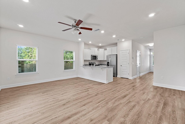 unfurnished living room featuring light wood-style flooring, visible vents, and recessed lighting