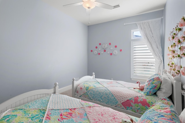 carpeted bedroom featuring a ceiling fan and baseboards