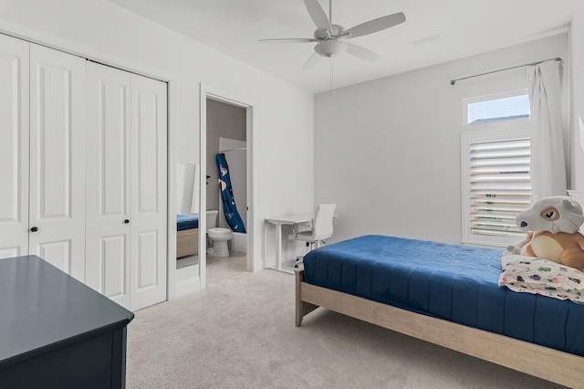 bedroom with ceiling fan, carpet floors, a closet, and connected bathroom