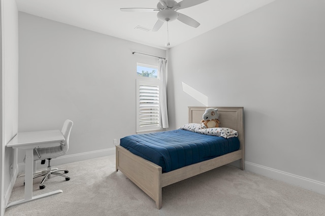 carpeted bedroom featuring a ceiling fan and baseboards