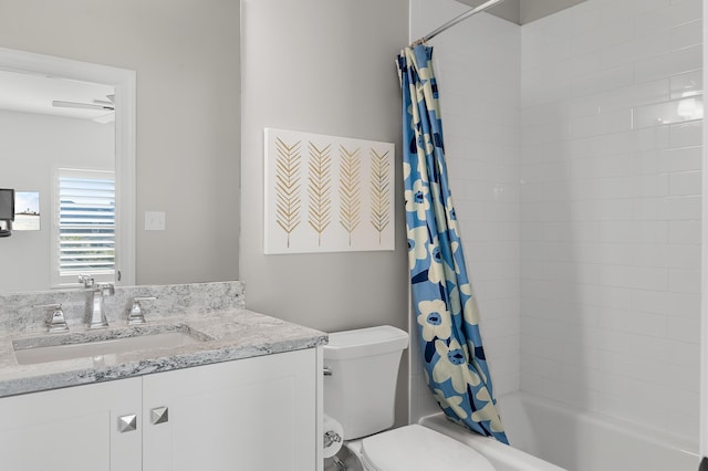 full bathroom featuring shower / bath combination with curtain, vanity, and toilet