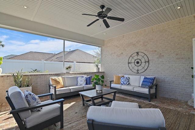 view of patio / terrace with ceiling fan, fence, and an outdoor living space