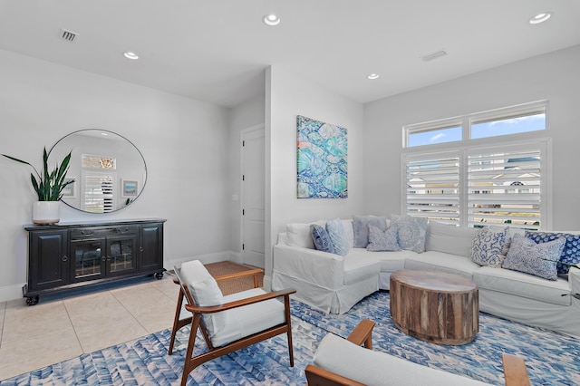 living room with light tile patterned floors, baseboards, visible vents, and recessed lighting