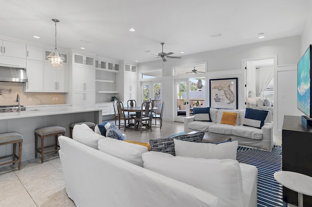 living room with light tile patterned floors, visible vents, a ceiling fan, and recessed lighting