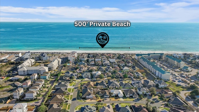 birds eye view of property featuring a beach view, a water view, and a residential view