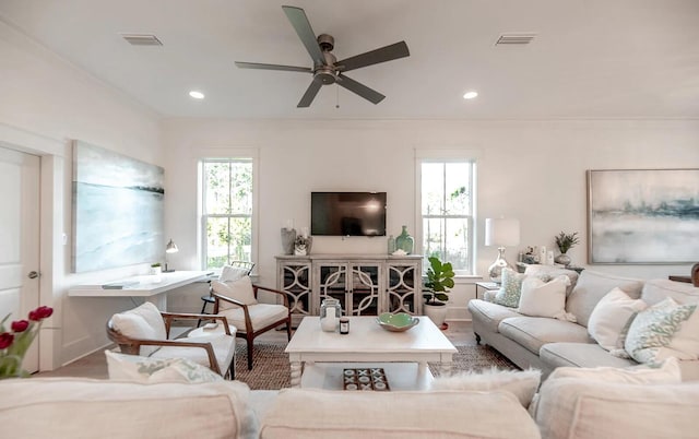 living area featuring ornamental molding, visible vents, and recessed lighting