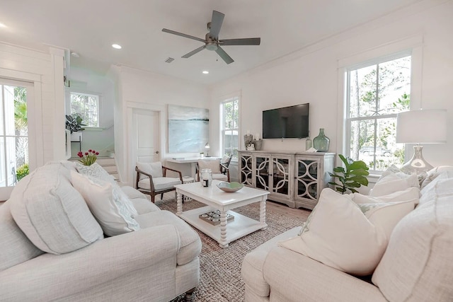 living room featuring recessed lighting, wood finished floors, a ceiling fan, visible vents, and crown molding