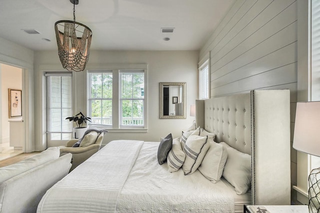 bedroom with a chandelier and visible vents