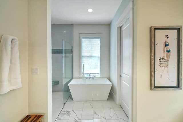 full bathroom with a shower, marble finish floor, and a freestanding bath