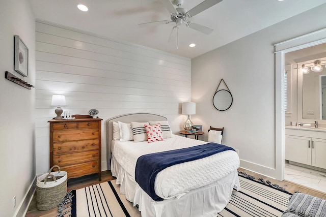 bedroom featuring light wood-style floors, recessed lighting, connected bathroom, and baseboards