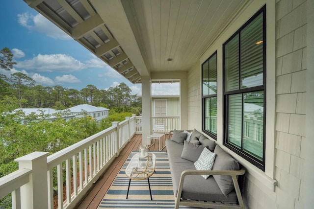 balcony with an outdoor living space and a sunroom