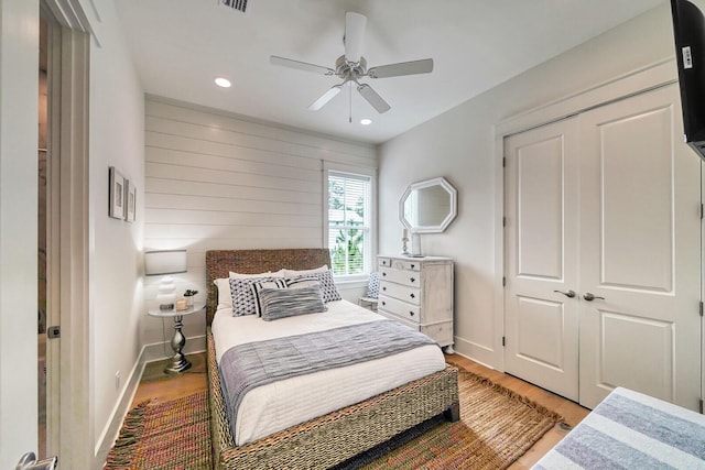 bedroom with light wood finished floors, a closet, visible vents, and baseboards