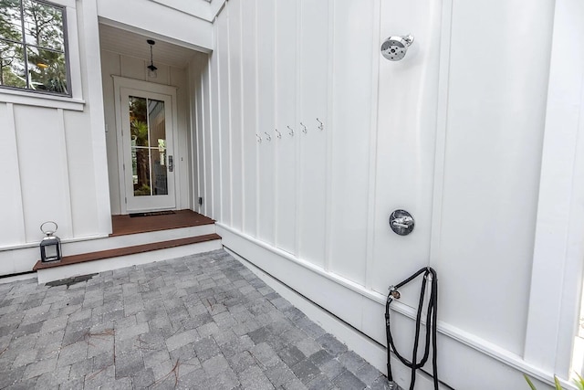 view of exterior entry with board and batten siding