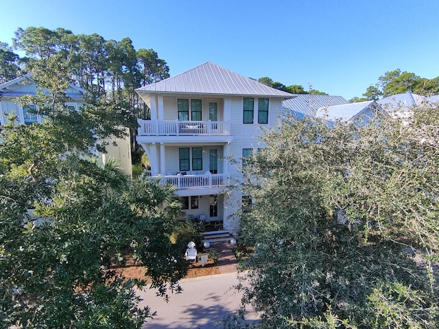 view of front facade with a balcony and metal roof