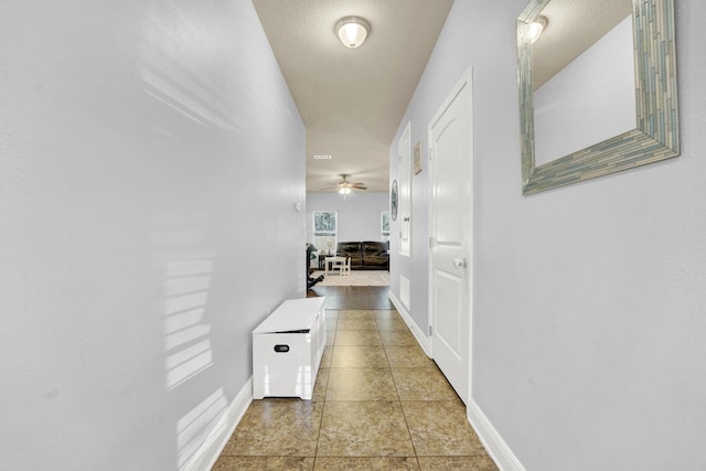 hall featuring baseboards