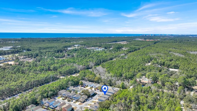 bird's eye view with a water view and a view of trees