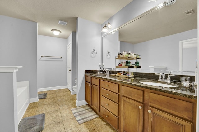 full bathroom featuring toilet, double vanity, visible vents, and a sink