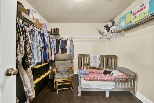 walk in closet with wood finished floors