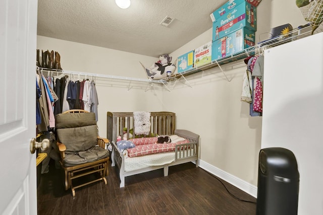 walk in closet featuring wood finished floors and visible vents