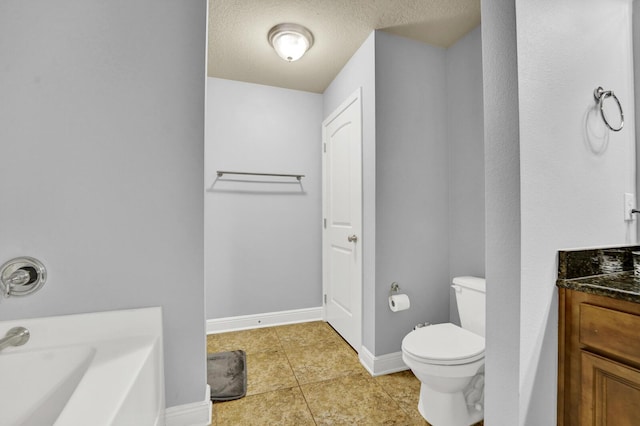 bathroom with baseboards, toilet, tile patterned floors, vanity, and a bath