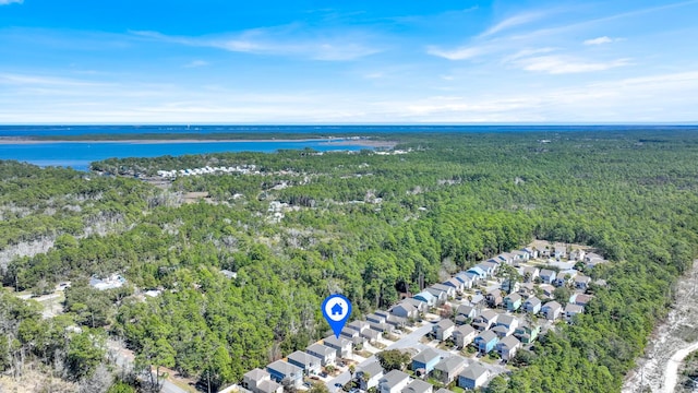 birds eye view of property with a water view, a residential view, and a view of trees