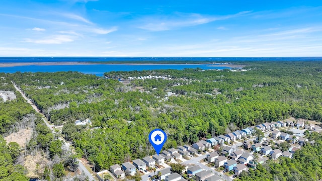 drone / aerial view with a water view, a wooded view, and a residential view