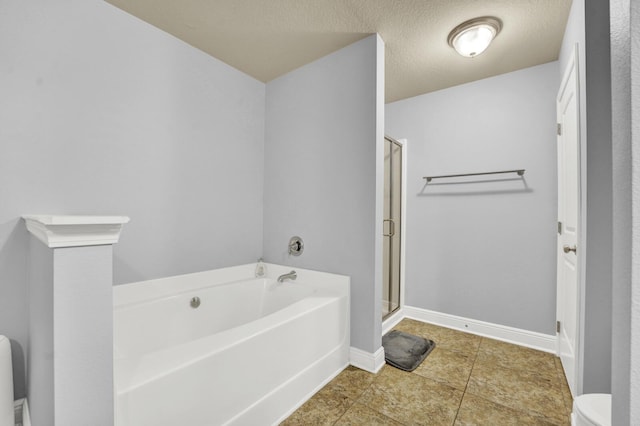 full bath featuring baseboards, toilet, a garden tub, a textured ceiling, and a shower stall