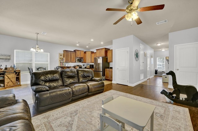 living room featuring dark wood-style floors, recessed lighting, visible vents, and baseboards