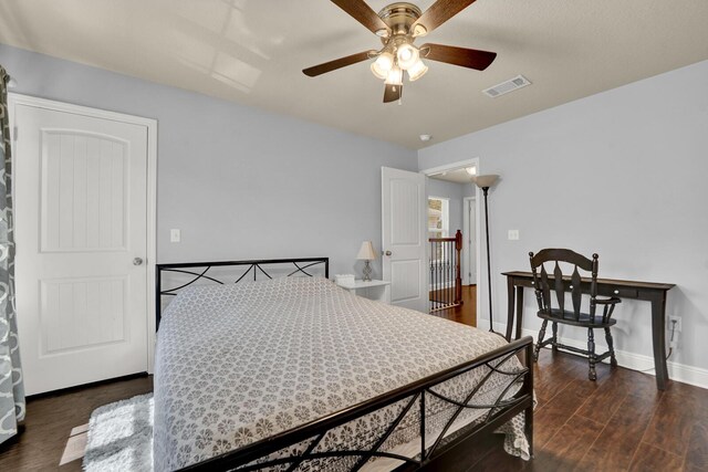 bedroom featuring visible vents, ceiling fan, baseboards, and wood finished floors